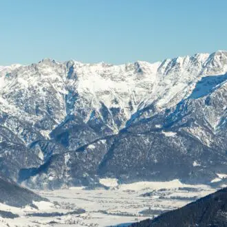Scenic Saalbach-Hinterglemm-Leogang skicircus area snow-covered alpine mountains horizon sharp peaks illuminated sunlight. Valley forests ski slopes, chairlifts winter holiday activities white slopes