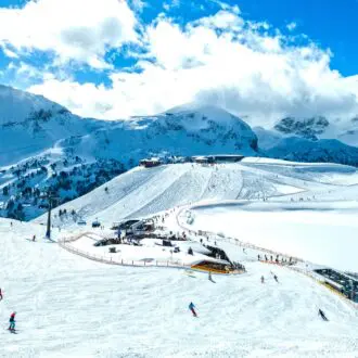 Obertauern, Salzburg area, Austria - Ski resort, hut, skiers and slope in Austrian Alps